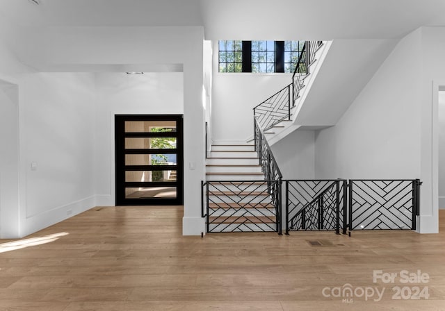 13702 Sage Thrasher Ln, Charlotte, NC 28278 - foyer entrance featuring wood finished floors, healthy amount of natural light, and stairs