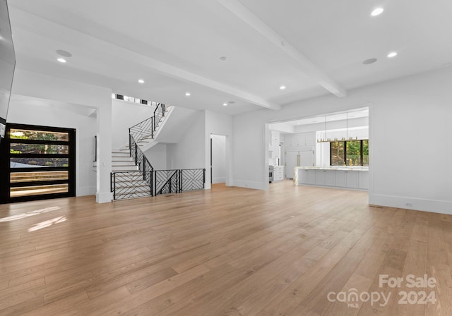 13702 Sage Thrasher Ln, Charlotte, NC 28278 - unfurnished living room featuring beam ceiling, light wood-style flooring, recessed lighting, and stairs