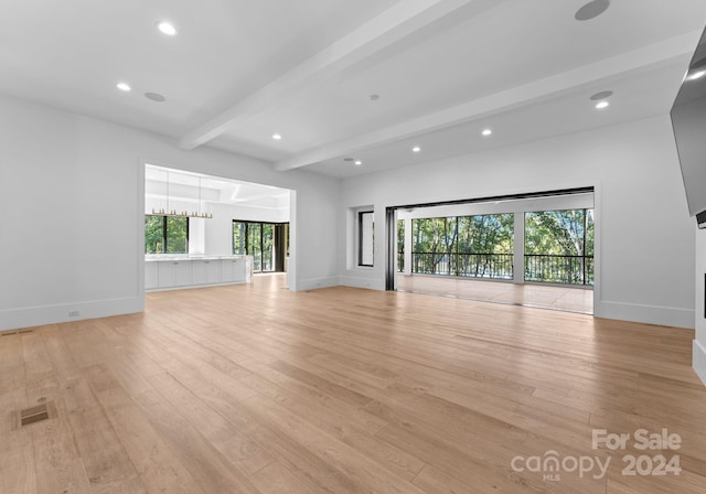 13702 Sage Thrasher Ln, Charlotte, NC 28278 - unfurnished living room featuring beam ceiling, light wood-style floors, recessed lighting, and a chandelier