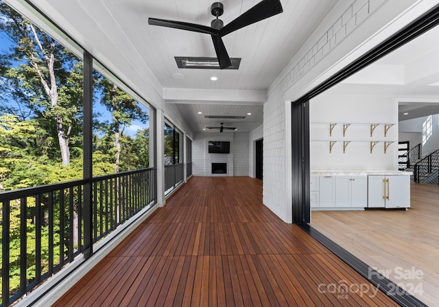 wooden deck featuring ceiling fan