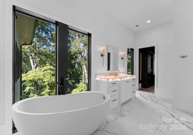 13702 Sage Thrasher Ln, Charlotte, NC 28278 - full bath featuring vanity, a freestanding bath, recessed lighting, and marble finish flooring