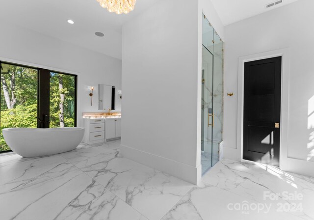13702 Sage Thrasher Ln, Charlotte, NC 28278 - full bathroom featuring vanity, a marble finish shower, a freestanding bath, marble finish floors, and a chandelier