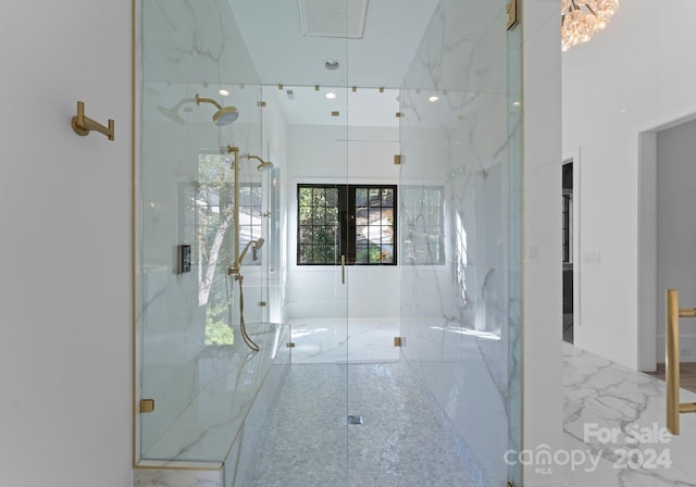 bathroom featuring a shower with shower door