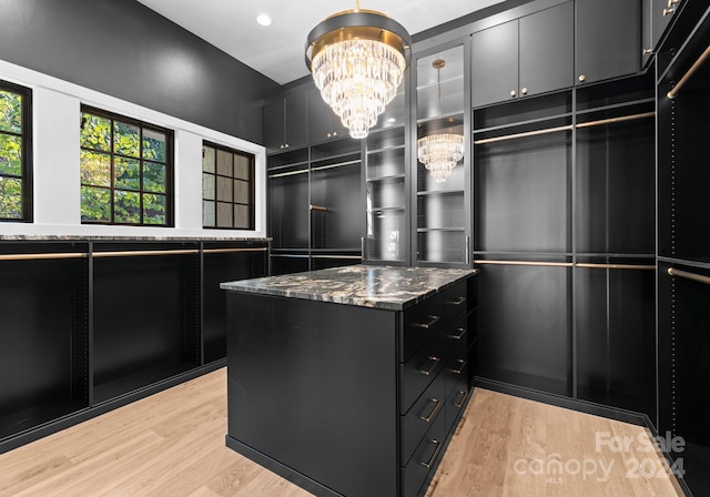13702 Sage Thrasher Ln, Charlotte, NC 28278 - walk in closet with a chandelier and light wood-type flooring