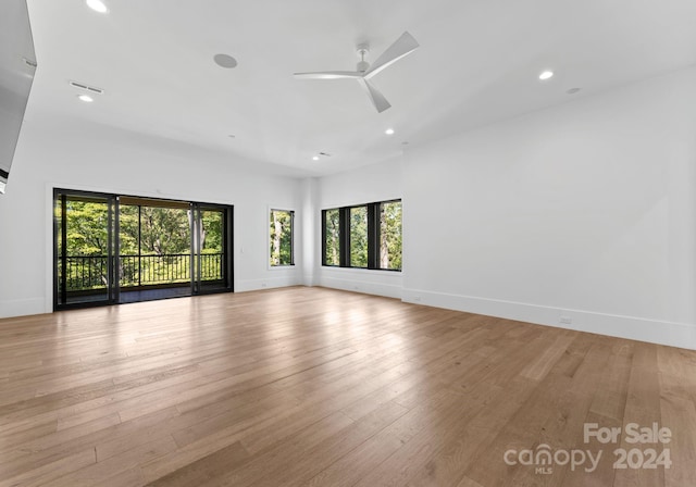 unfurnished room with light wood-type flooring and ceiling fan