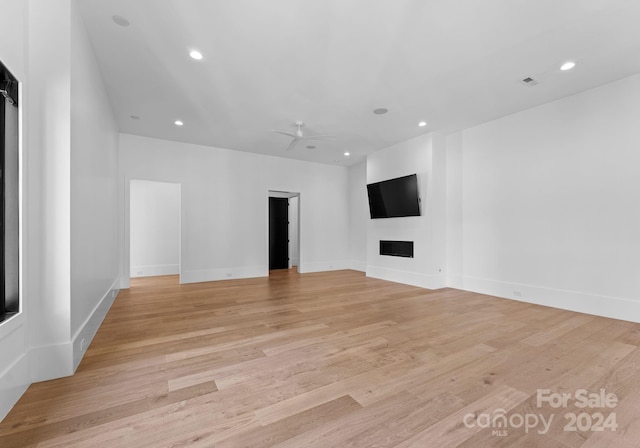 13702 Sage Thrasher Ln, Charlotte, NC 28278 - unfurnished living room with a fireplace, recessed lighting, light wood-style floors, and a ceiling fan