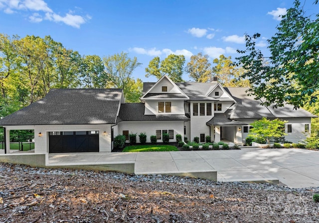 13702 Sage Thrasher Ln, Charlotte, NC 28278 - view of front facade featuring concrete driveway, a garage, a chimney, and a shingled roof