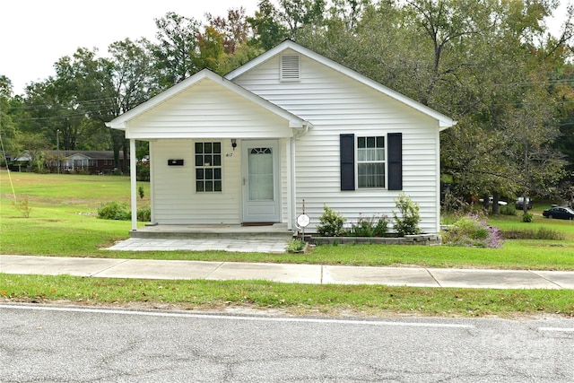 bungalow-style house with a front lawn