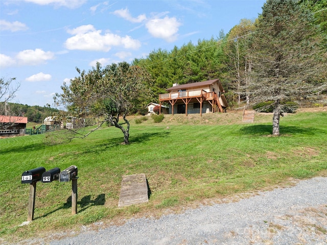 view of front of home featuring a wooden deck and a front lawn