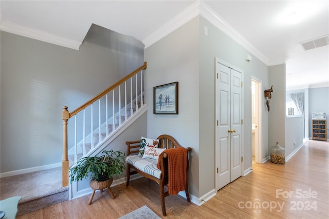 interior space featuring crown molding and hardwood / wood-style floors