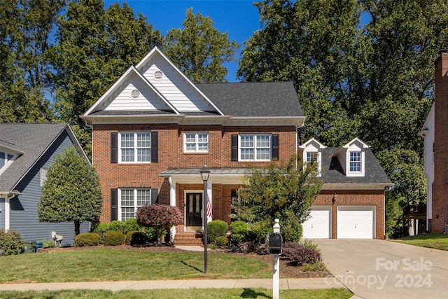 view of front facade featuring a front yard and a garage