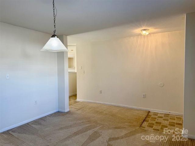 unfurnished dining area featuring carpet and baseboards