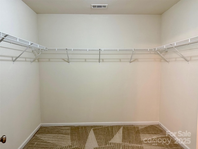 spacious closet with carpet floors and visible vents