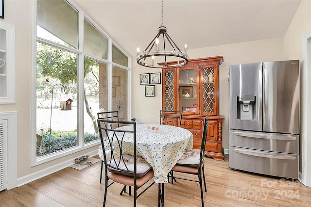 dining room featuring a notable chandelier and light wood-type flooring