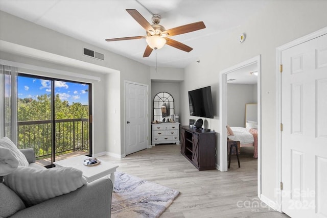 living room with ceiling fan and light hardwood / wood-style flooring