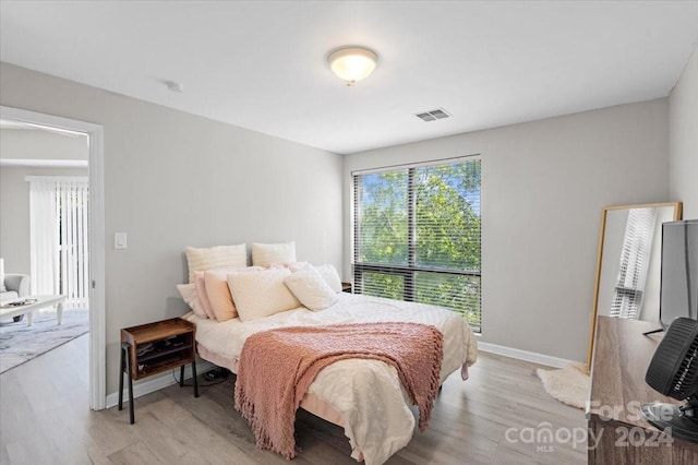 bedroom with light hardwood / wood-style floors