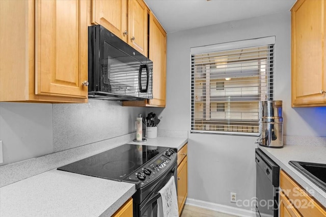 kitchen with black appliances, sink, and light brown cabinets