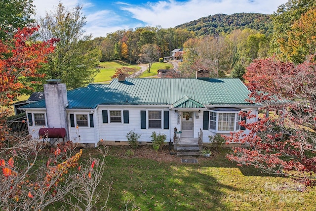 396 Will Hyatt Rd, Waynesville, NC 28786 - view of front of house with a chimney, a metal roof, crawl space, a front lawn, and a mountain view
