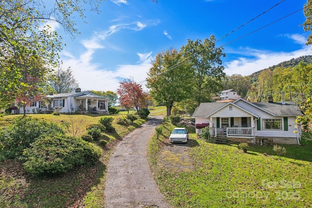 396 Will Hyatt Rd, Waynesville, NC 28786 - view of front facade featuring covered porch, a front yard, driveway, and crawl space