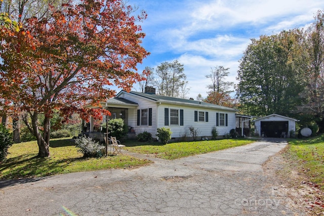 396 Will Hyatt Rd, Waynesville, NC 28786 - view of front of home with a detached garage, an outdoor structure, a chimney, and a front yard