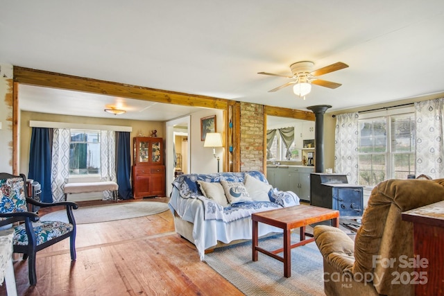 396 Will Hyatt Rd, Waynesville, NC 28786 - living room with a wood stove, light wood-style floors, and ceiling fan