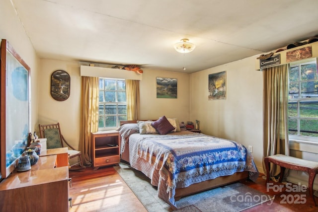 396 Will Hyatt Rd, Waynesville, NC 28786 - bedroom featuring multiple windows and wood finished floors