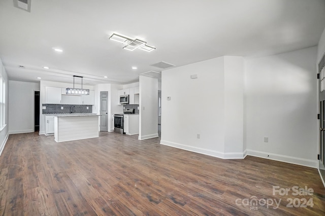 unfurnished living room featuring dark hardwood / wood-style floors