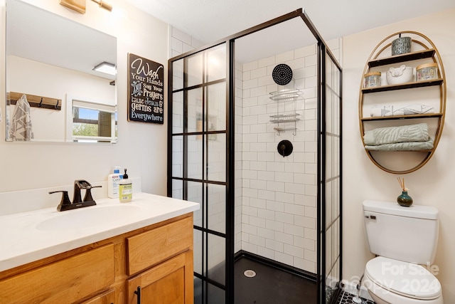 bathroom with walk in shower, vanity, and toilet