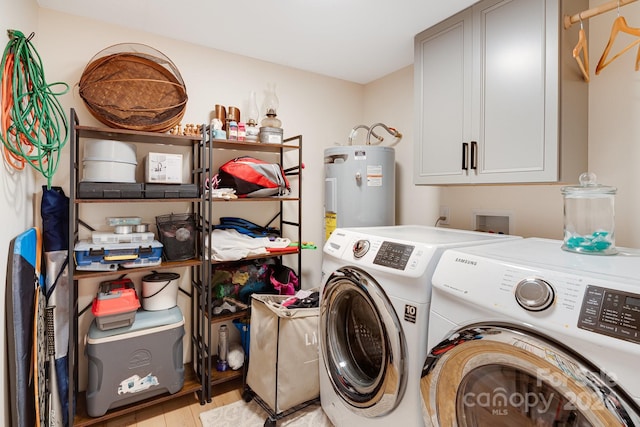 clothes washing area with electric water heater, separate washer and dryer, light hardwood / wood-style flooring, and cabinets