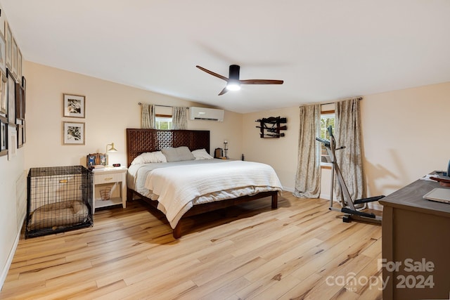 bedroom featuring light hardwood / wood-style floors, a wall mounted air conditioner, vaulted ceiling, and ceiling fan