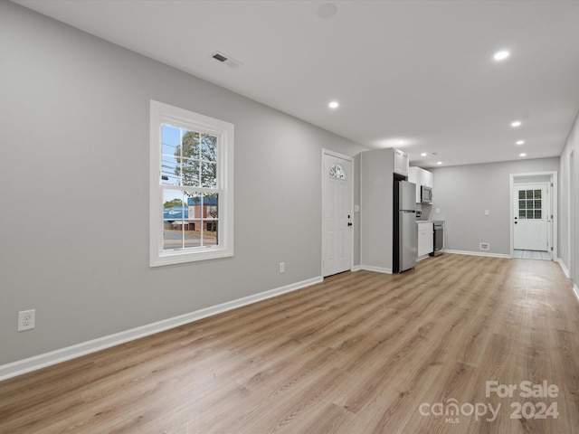 unfurnished living room featuring light hardwood / wood-style flooring