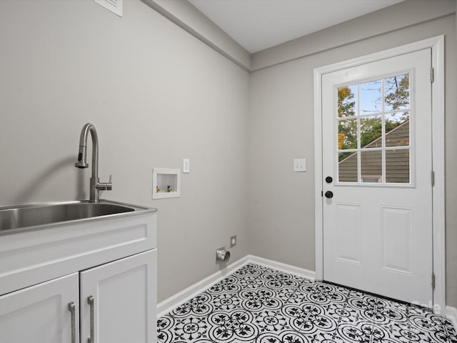 clothes washing area featuring hookup for a washing machine, hookup for an electric dryer, sink, light tile patterned floors, and cabinets