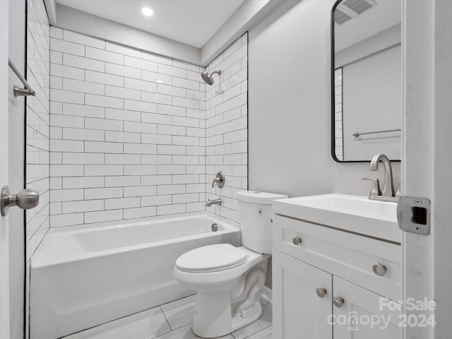 full bathroom featuring vanity, tiled shower / bath combo, and toilet