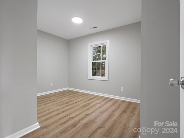 empty room with light hardwood / wood-style flooring