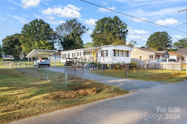 view of front facade featuring a front lawn and a carport