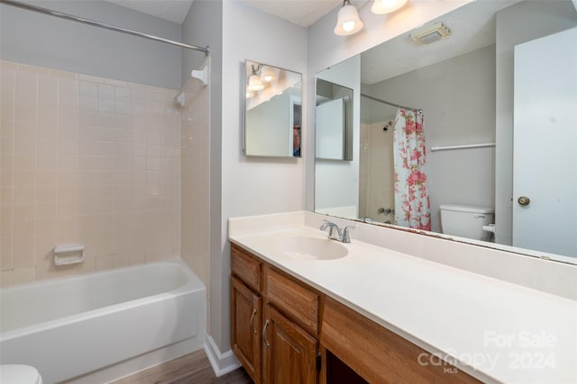 full bathroom with vanity, shower / bath combination with curtain, wood-type flooring, and toilet