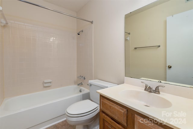 full bathroom featuring vanity, toilet, tile patterned flooring, and tiled shower / bath