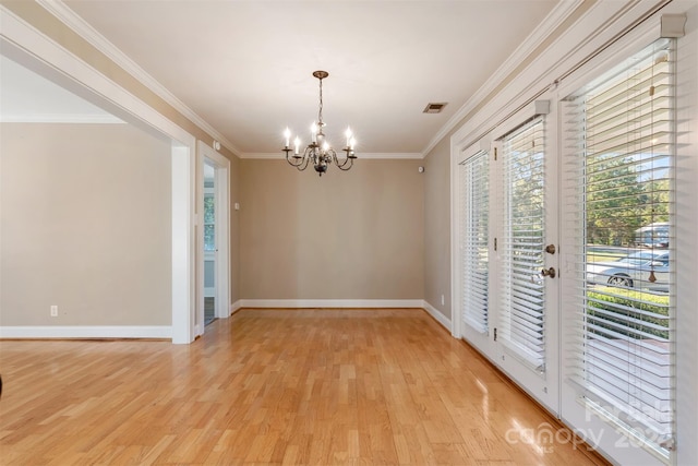 unfurnished dining area with a notable chandelier, crown molding, and light hardwood / wood-style flooring