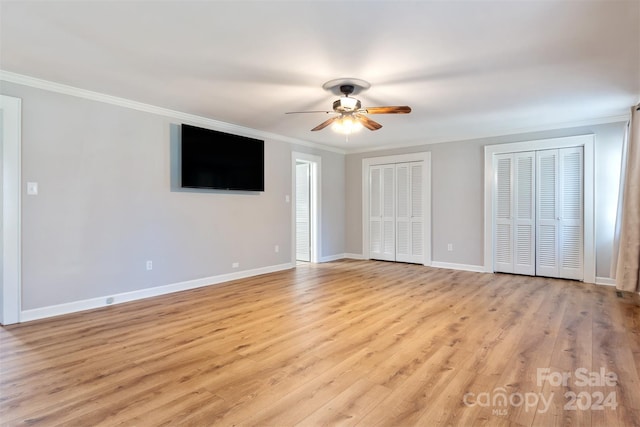 interior space featuring ornamental molding, light wood-type flooring, and ceiling fan