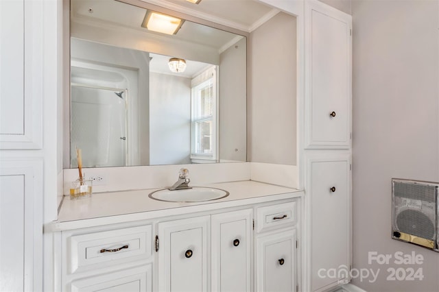 bathroom featuring ornamental molding, vanity, and heating unit