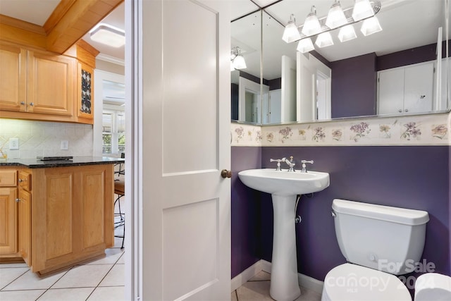 bathroom with ornamental molding, tile patterned floors, decorative backsplash, and toilet