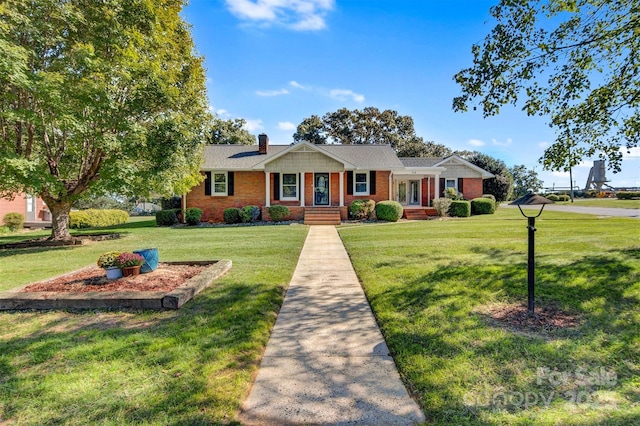 ranch-style house featuring brick siding, a chimney, and a front yard