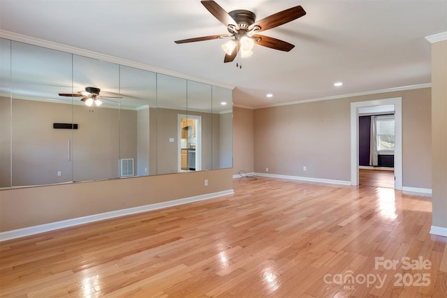 unfurnished room with ornamental molding, light wood-style flooring, and visible vents