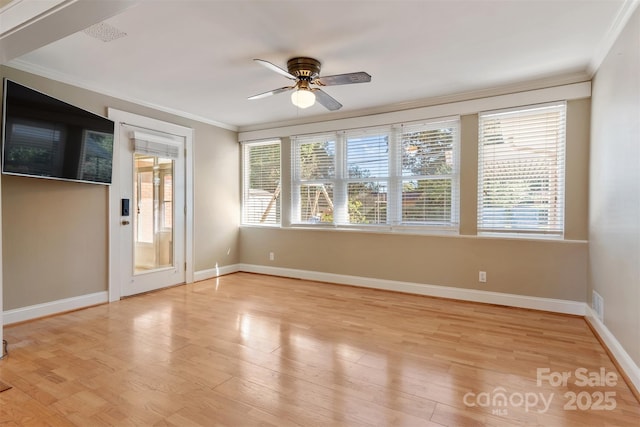 unfurnished room with a ceiling fan, baseboards, crown molding, and light wood finished floors