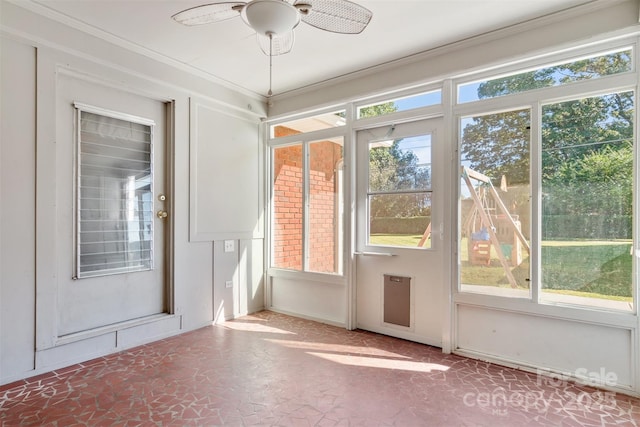 doorway to outside with ceiling fan and ornamental molding