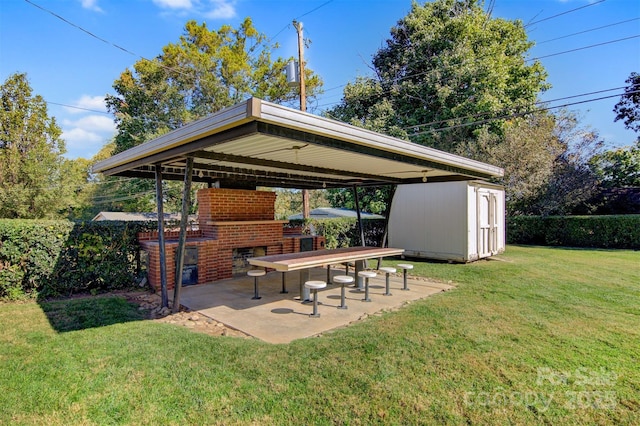 view of yard with an outbuilding, a storage unit, a patio area, and a fenced backyard