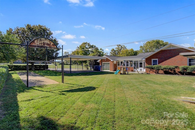 view of yard featuring a playground and fence