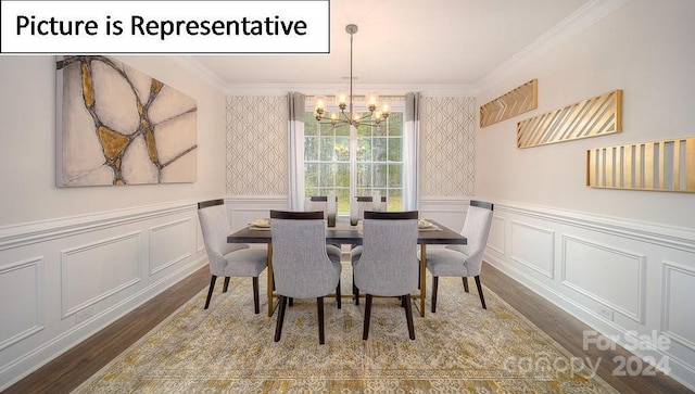dining area featuring crown molding, a decorative wall, a chandelier, wood finished floors, and wallpapered walls