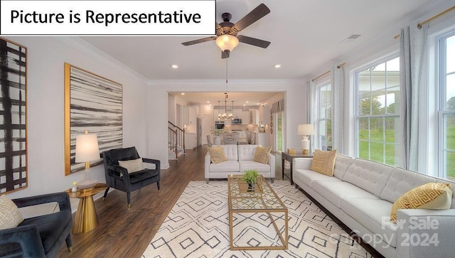 living room featuring crown molding, ceiling fan with notable chandelier, visible vents, stairway, and wood finished floors