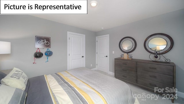 bedroom featuring light carpet and baseboards